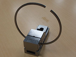 Piston ring secured in a fixture