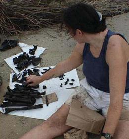 Archeaologist with metal on beach