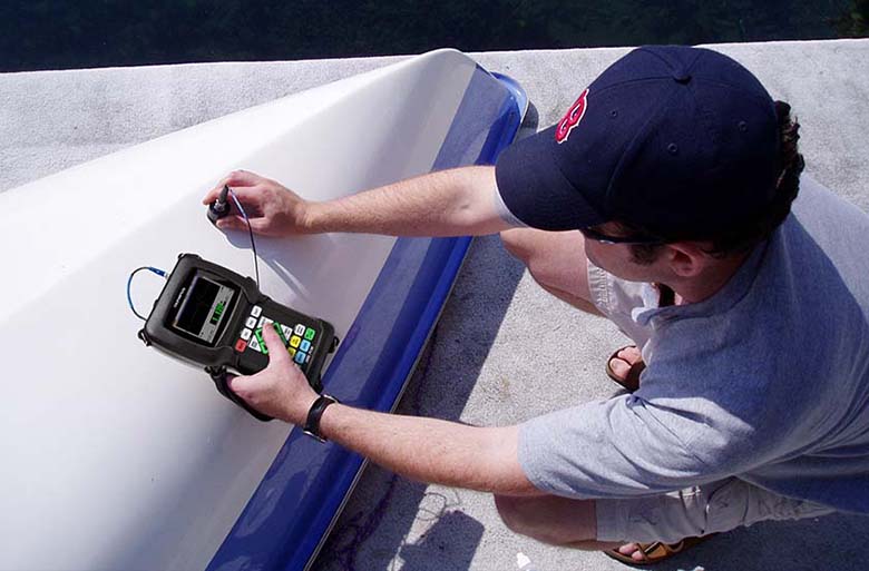 Using an Olympus 38DL PLUS Ultrasonic Thickness Gage on a fiberglass boat hull